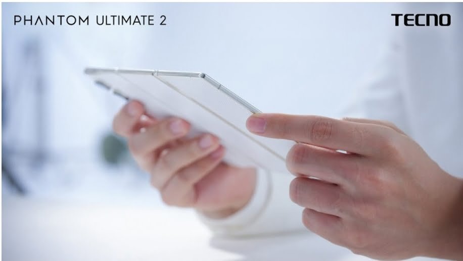 A man is holding the Tecno phantom ultimate 2 smartphone in hand