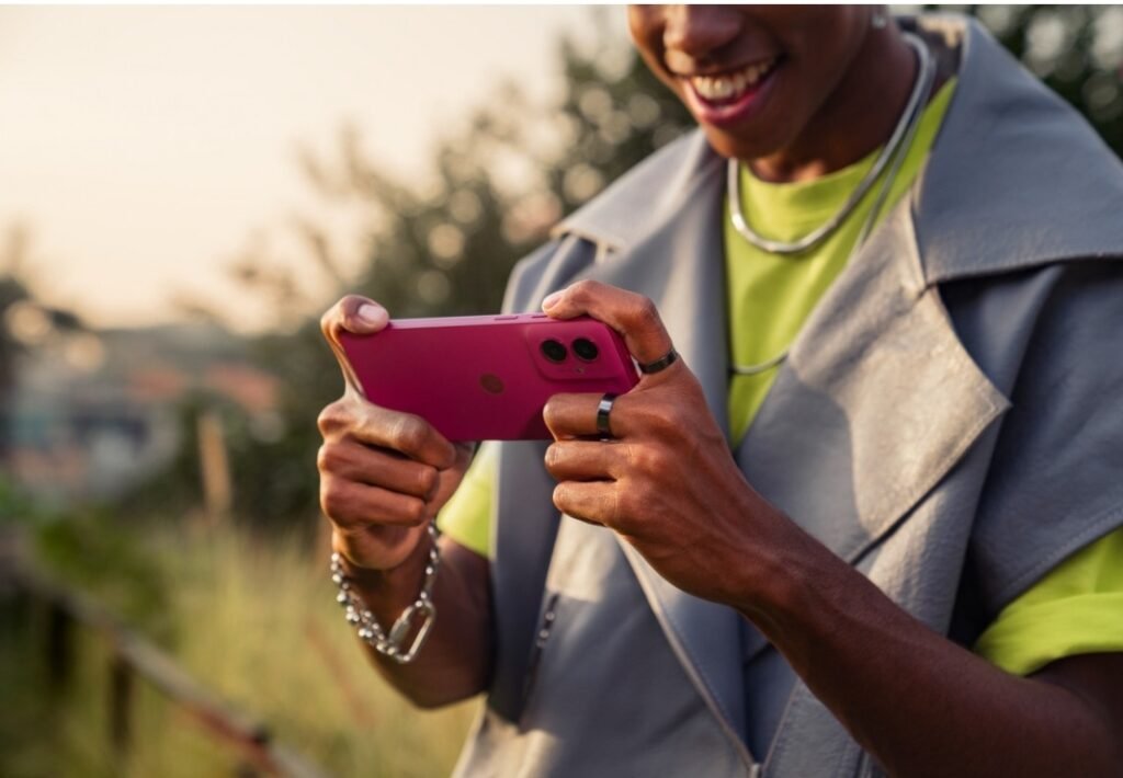 A model is holding the Moto G55